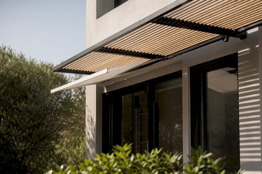 Exterior window with awning and pergola shading