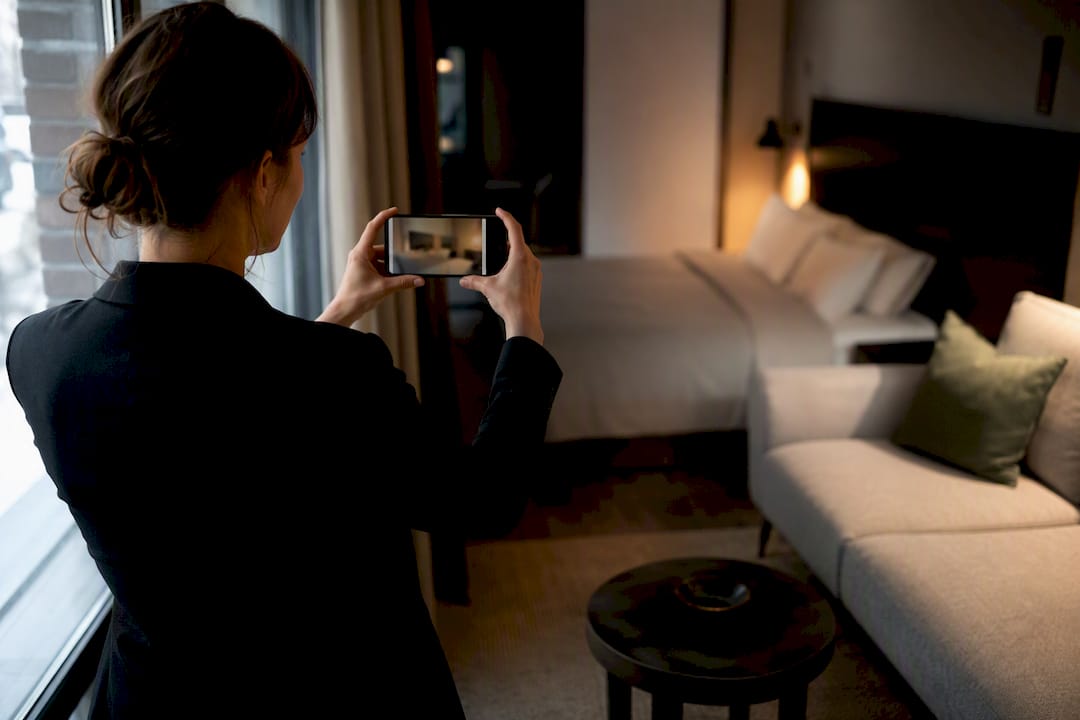 Manager photographing a dim rental room