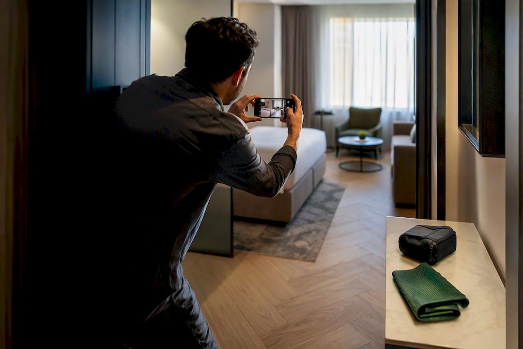 Manager capturing a serviced apartment listing photo