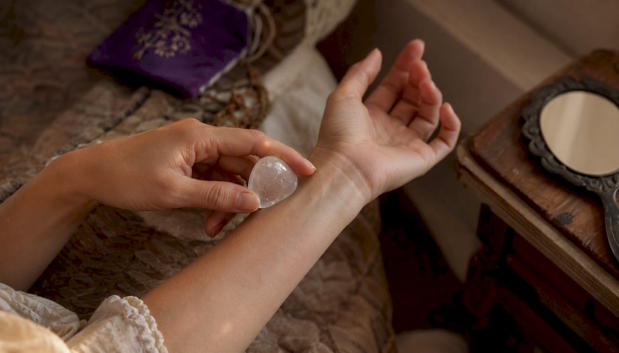 Hands testing crystal temperature on wrist