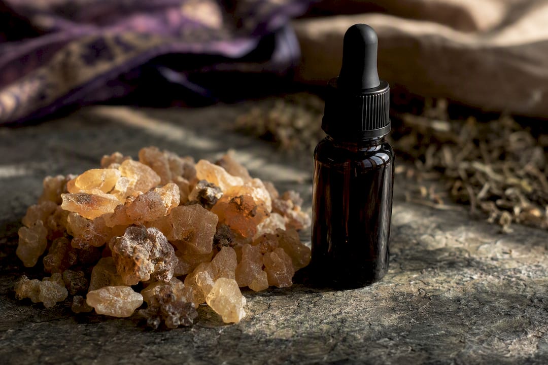 Frankincense resin pieces with essential oil bottle