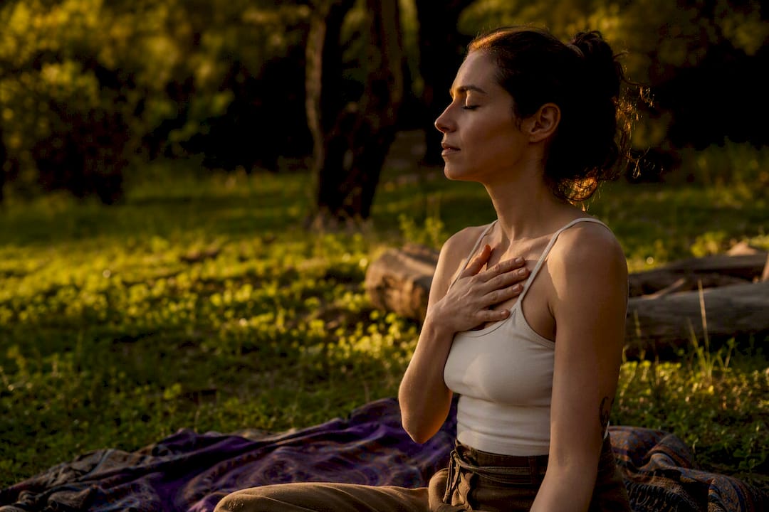 Person centering breath with hand on chest