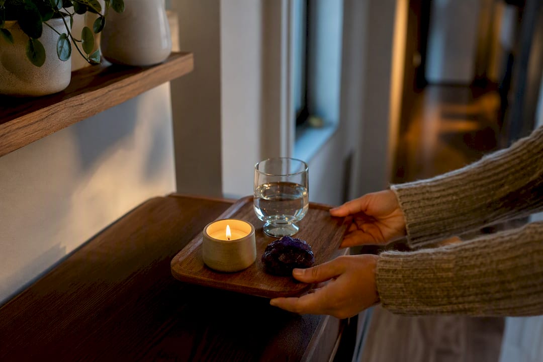 Hands moving a small portable altar tray
