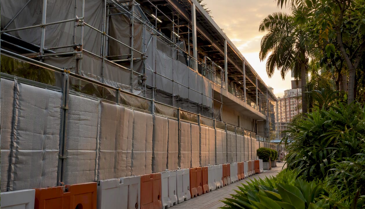 Construction site with noise mitigation near MRT station