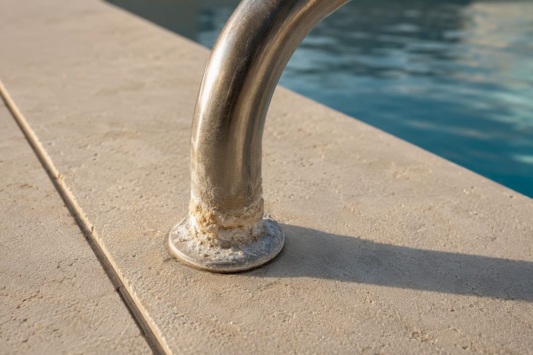 Salt residue on pool handrail base