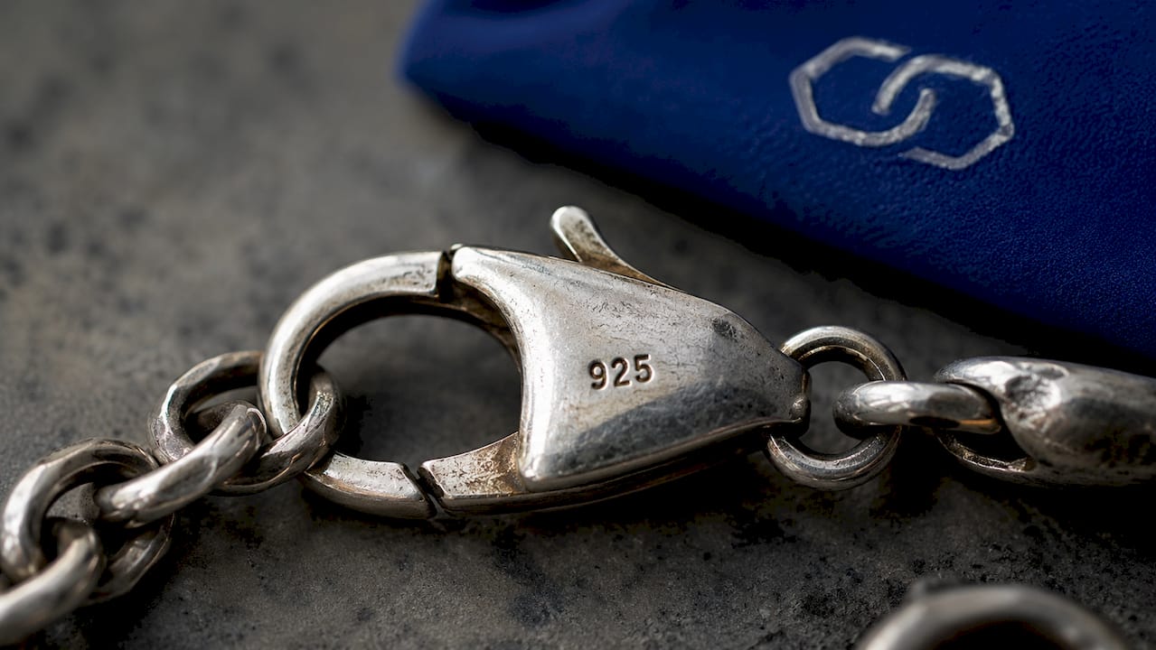 Close-up of silver bracelet clasp with 925 purity mark