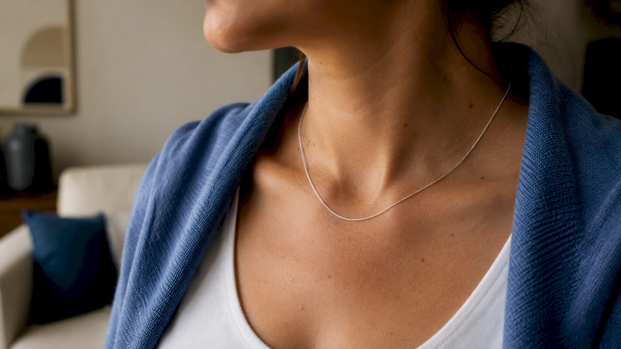 Close-up of silver chain worn against skin