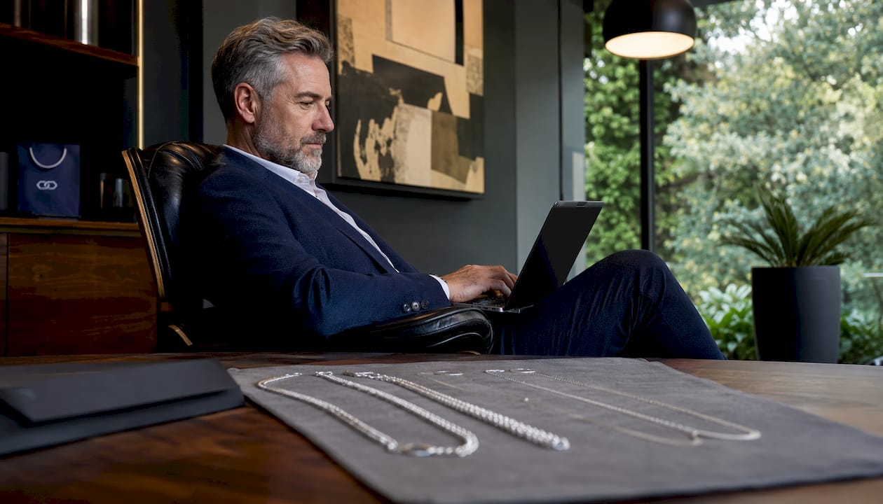 Man browsing silver chains catalog on tablet