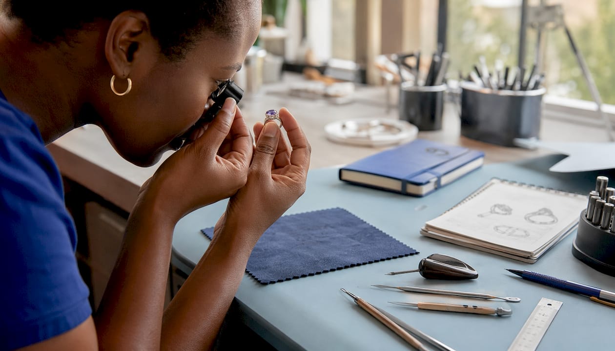 Overhead view of gemstone inspection in silver jewellery