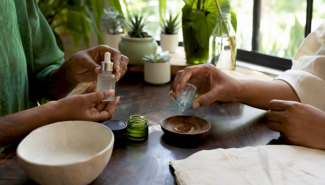 Hands layering niacinamide and copper peptide serums