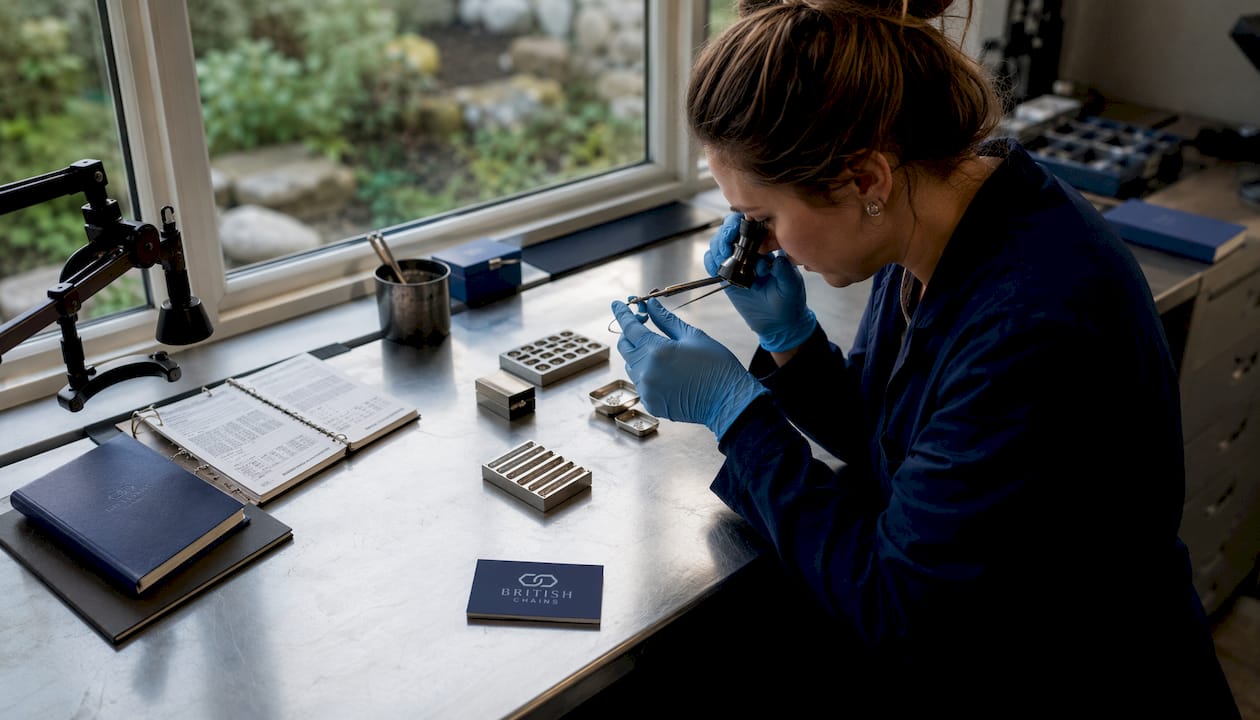 Female metallurgist inspecting jewelry hallmark