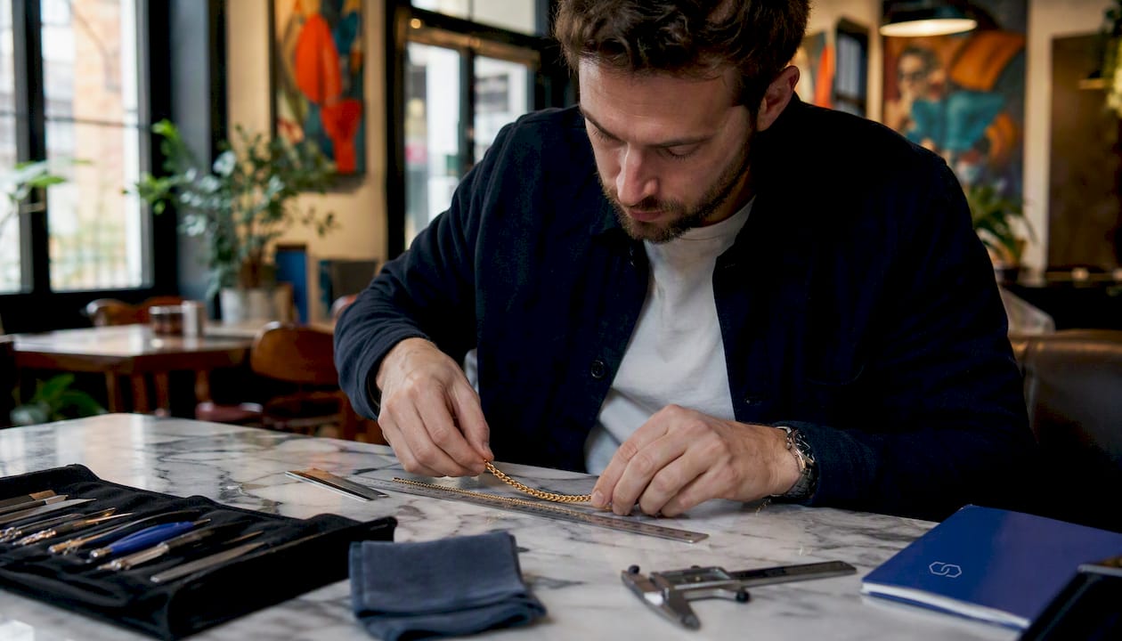 Jeweler measuring gold-filled baseball chain length
