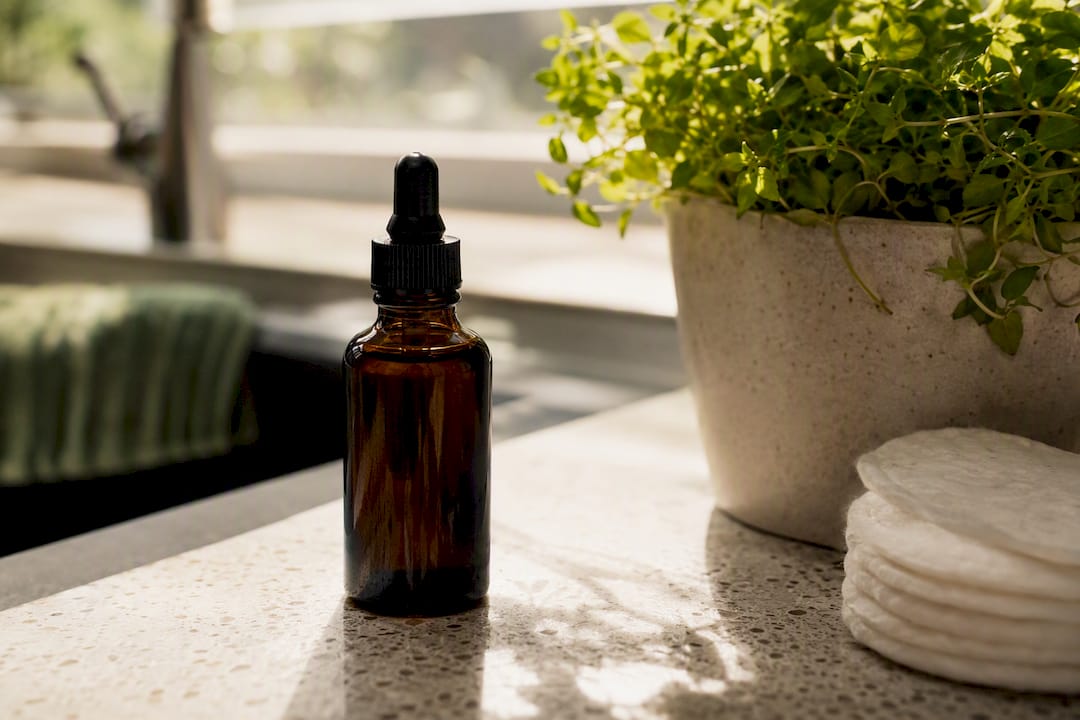 Dark glass vitamin C serum bottle on vanity