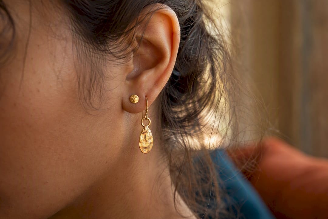 Close-up of drop and dangle earrings on ear