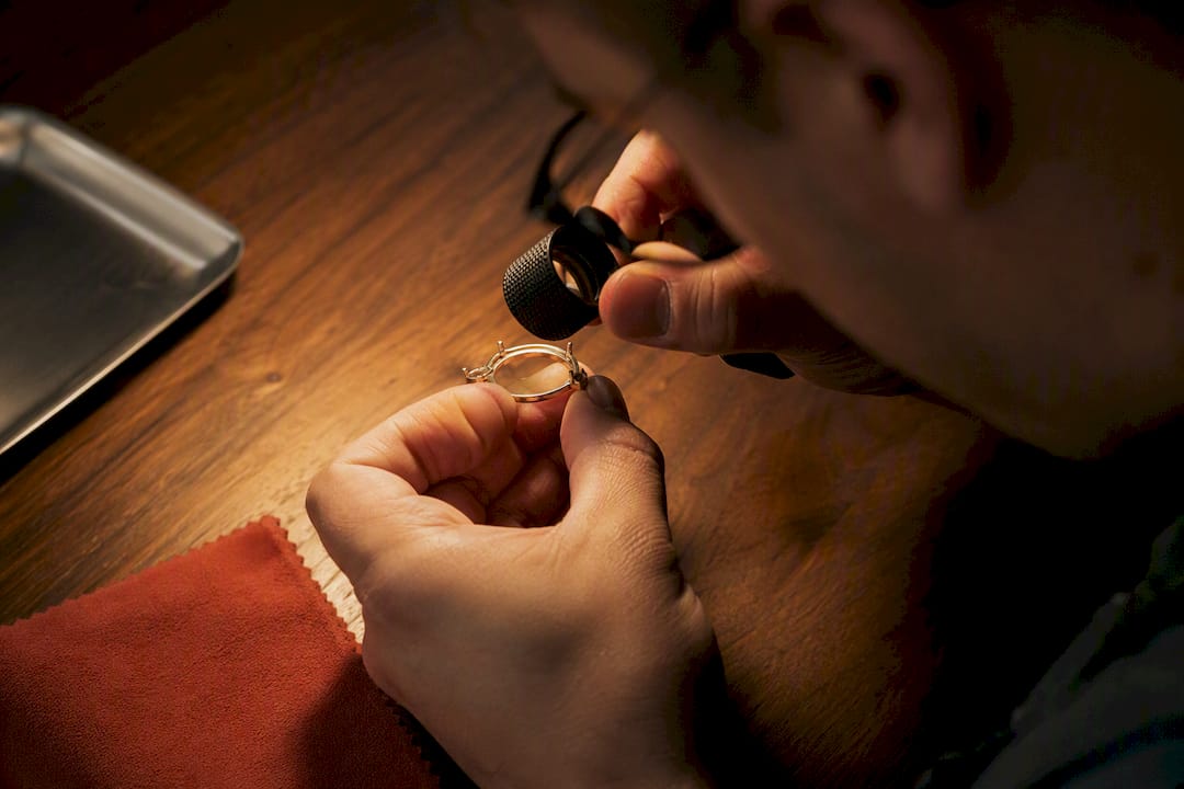 Loupe examining an indistinct jewelry hallmark