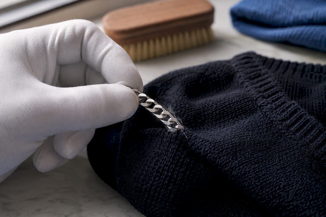 Chain link caught on jumper fibres