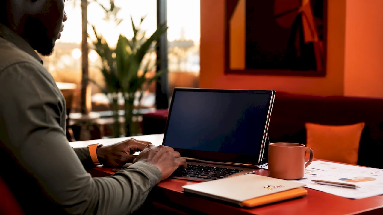 Hands typing at laptop handling security alerts