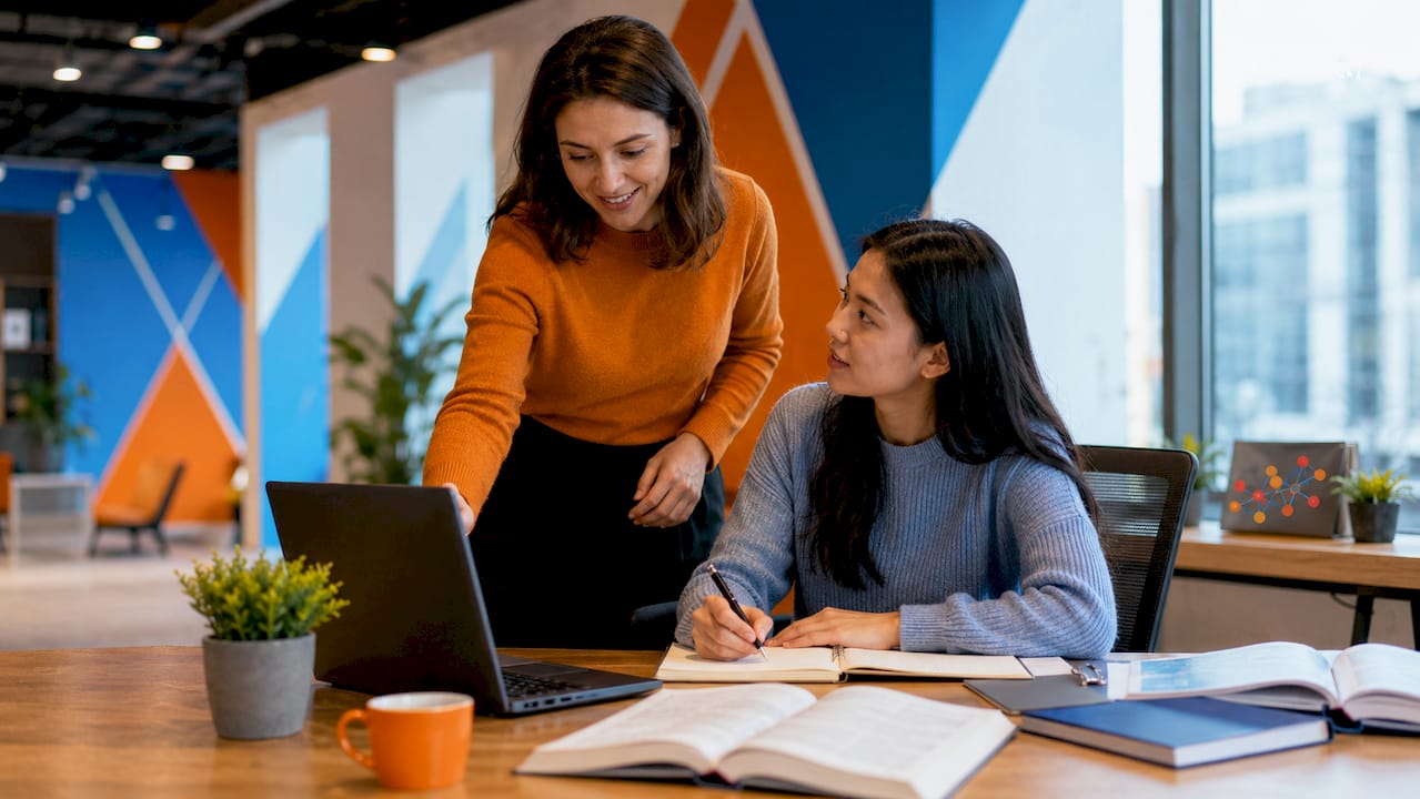 Mentor guiding junior cybersecurity professional