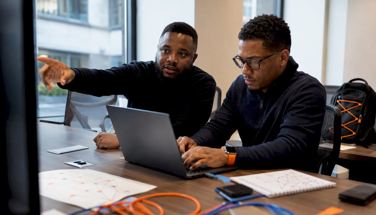 Two men collaborating on cyber incident response