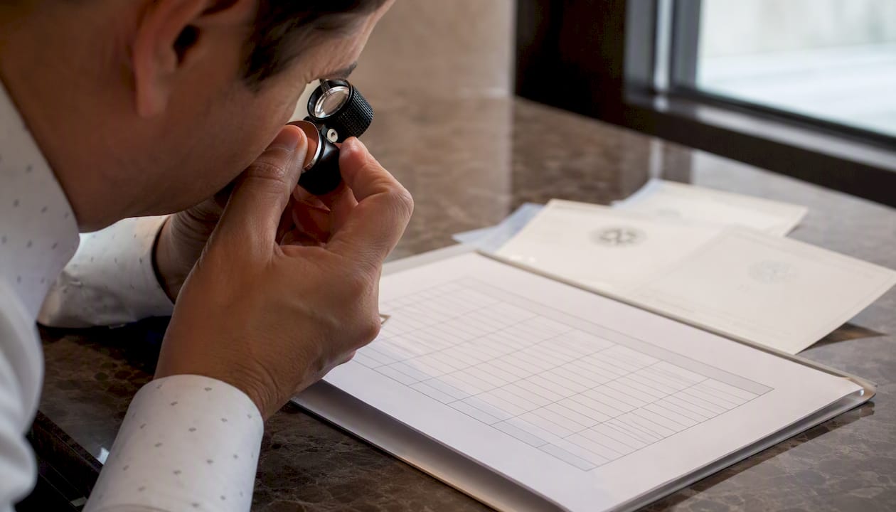 Hand examining checklist with magnifying glass