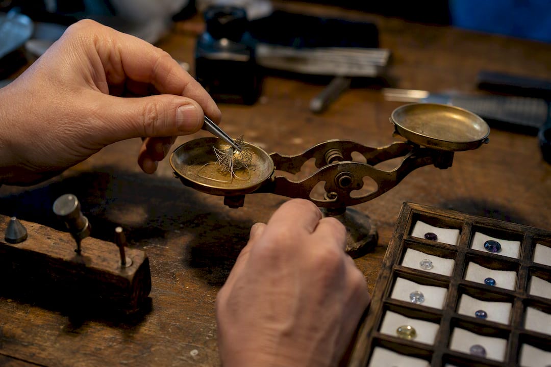 Jeweler weighing metals and gemstones