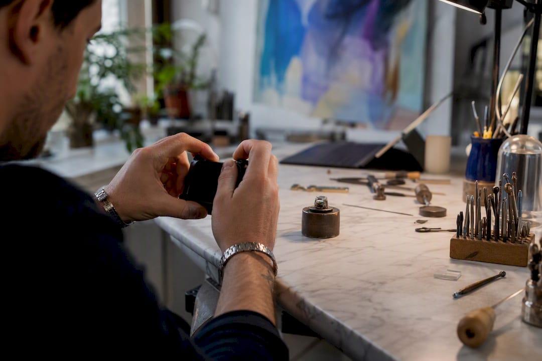 Jeweler photographing custom ring progress