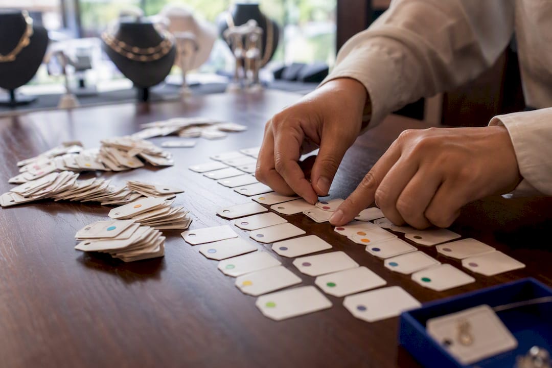 Hands sorting SKU coded tags