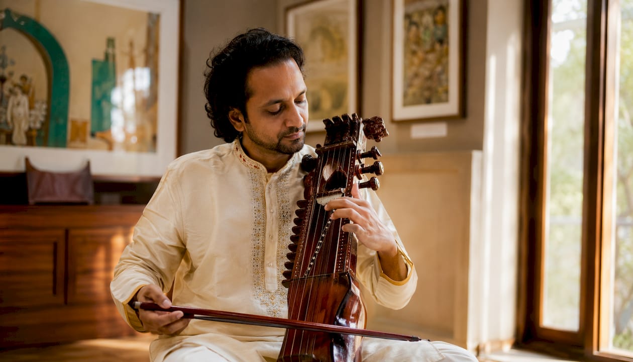 Hands sliding bow on sarangi in slow alap