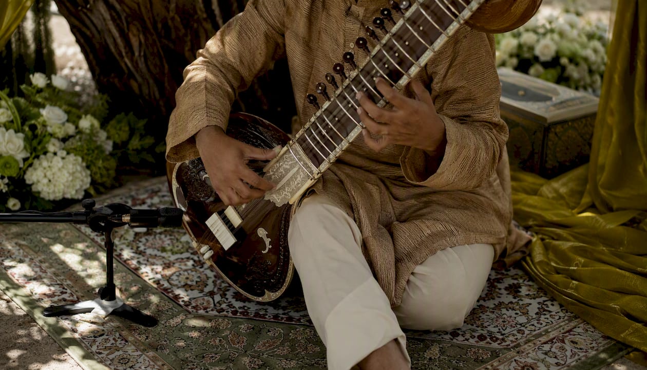 Rajib Karmakar sitarrajib Live Band vs DJ: What Couples Need to Know 3 Solo sitarist performing at wedding ceremony
