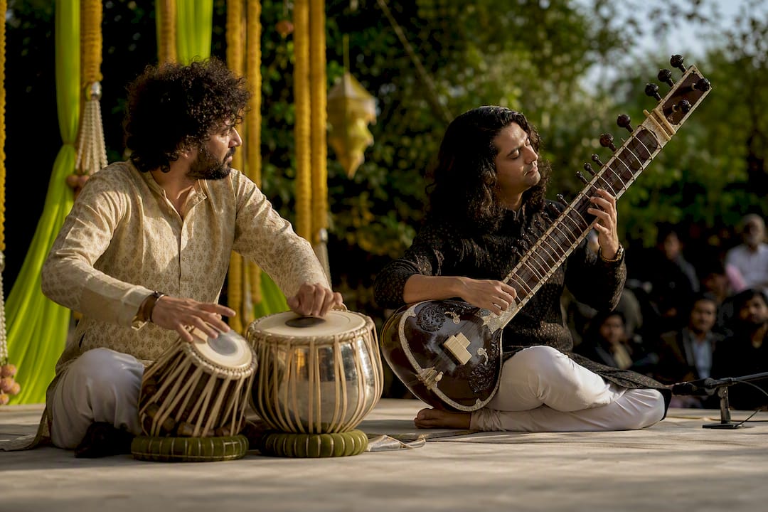Rajib Karmakar sitarrajib Types of Live Music Acts for Cultural Events: A Planner's Guide 3 Band performing at outdoor festival
