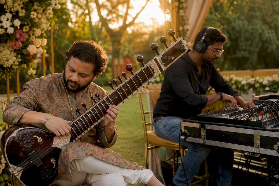 Rajib Karmakar sitarrajib What Is a Destination Wedding Music Act? A Planning Guide 2 Sound technician and musician preparing for wedding