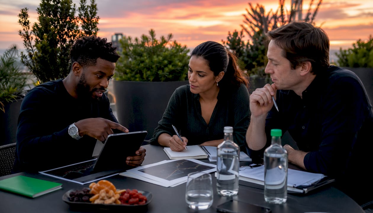 Traders collaborating on backtesting software features