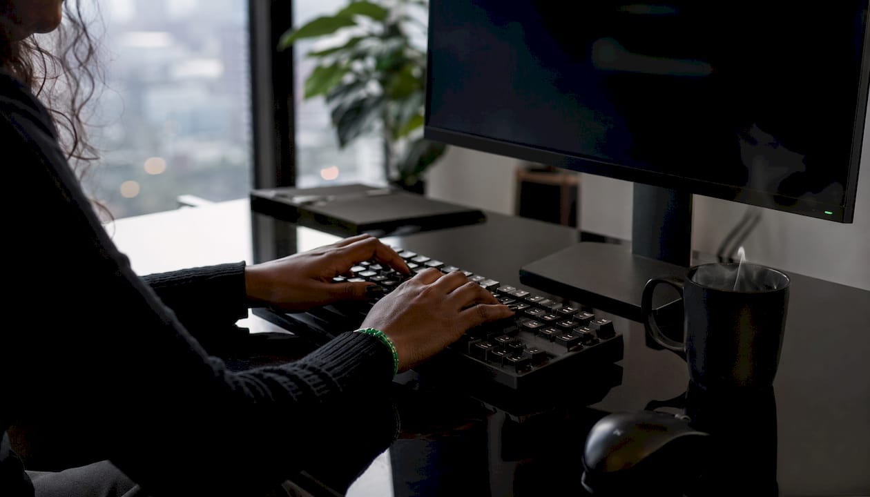 Close-up of hands coding brokerage API integration