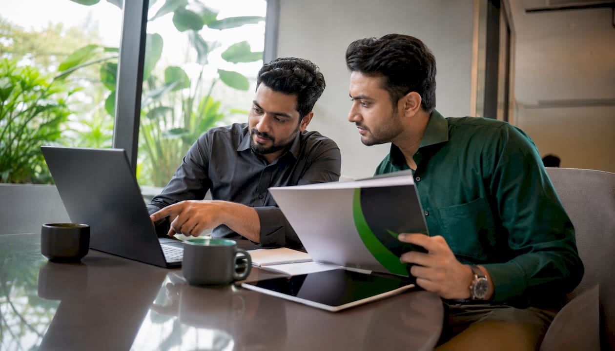 Colleagues discussing client quote software options