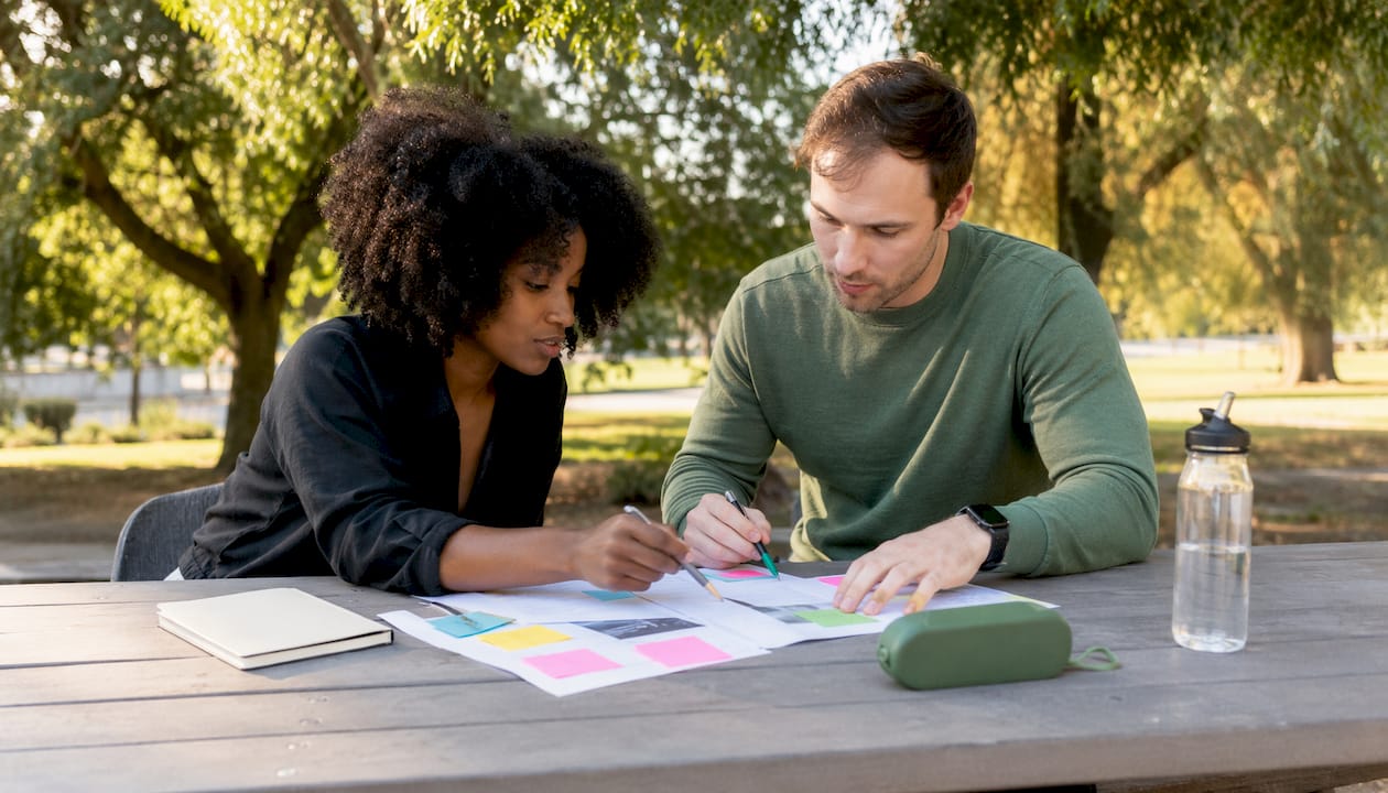 Hands editing business proposal documents together