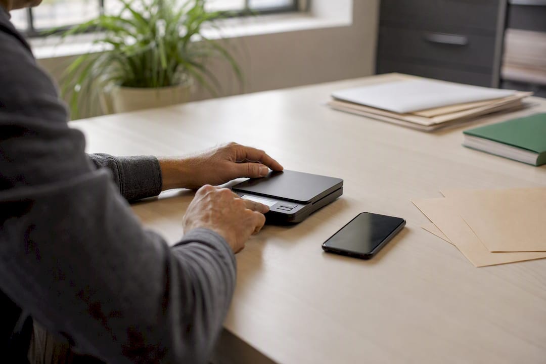 Hands using calculator and smartphone on table