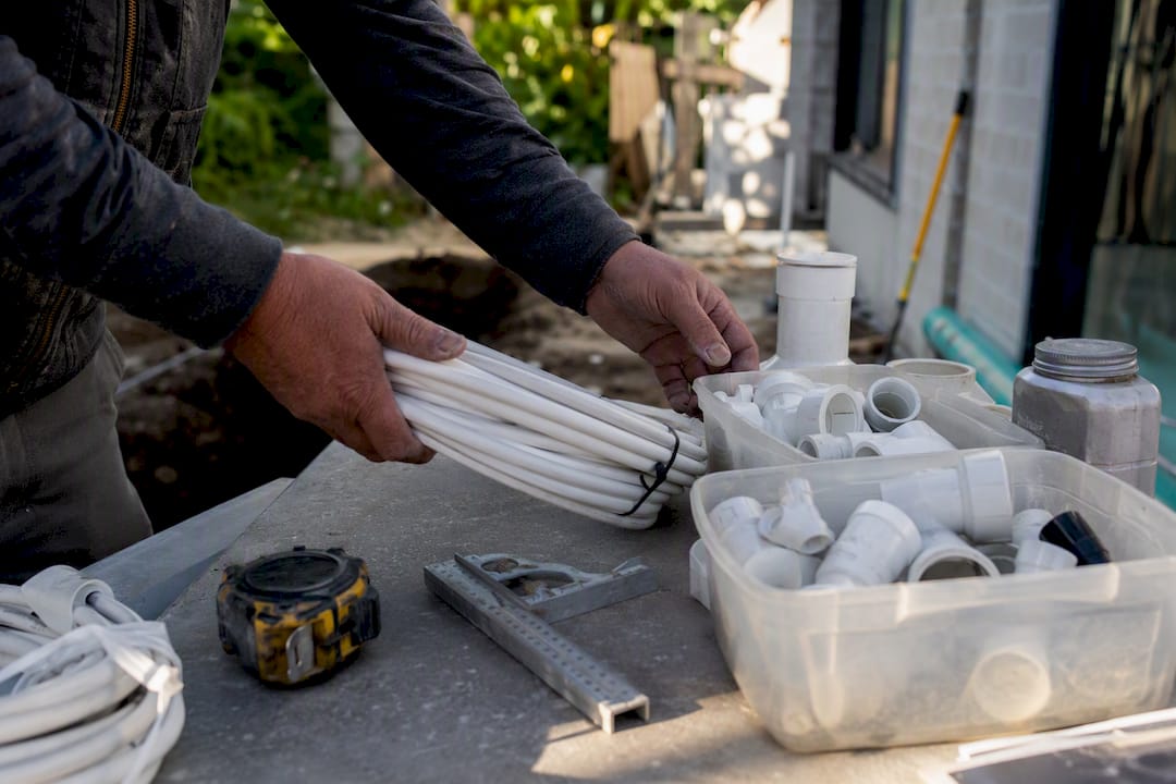 Hands organizing construction materials
