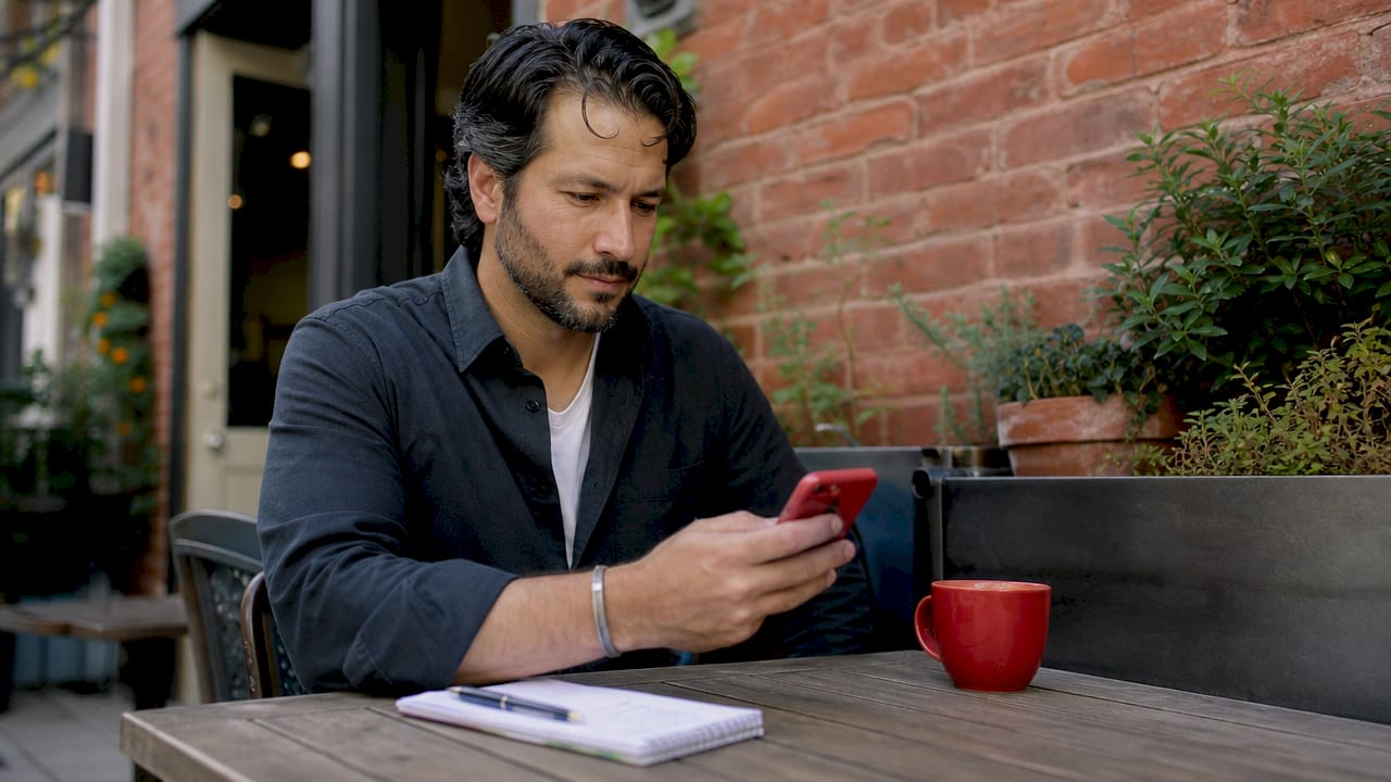 Hands holding phone checking shift notifications