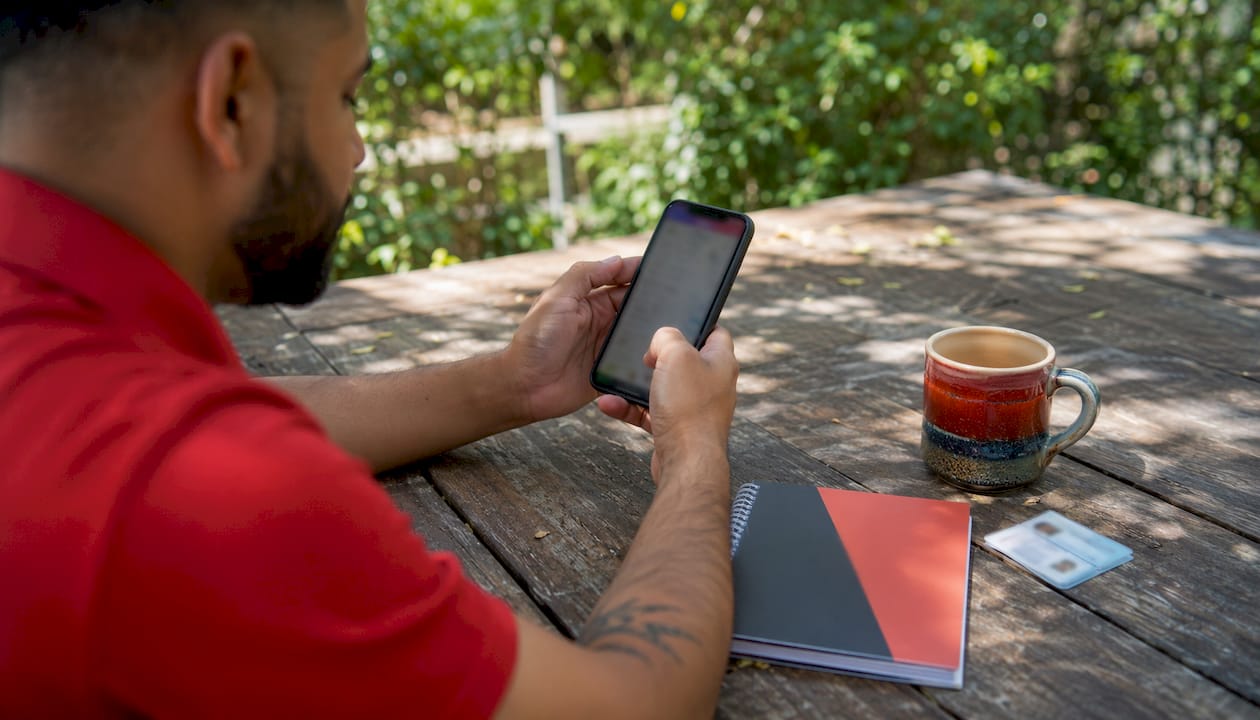 Overhead view of manager updating shifts on mobile device