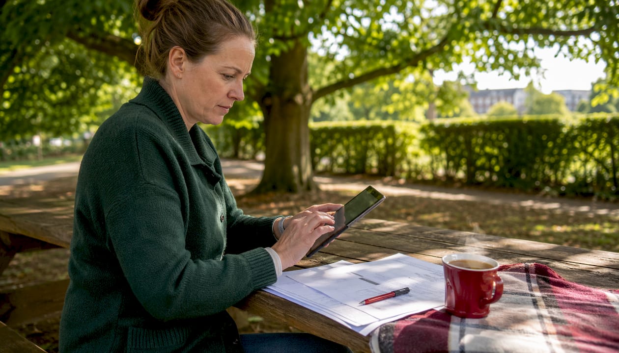 Manager reviewing scheduling report on tablet