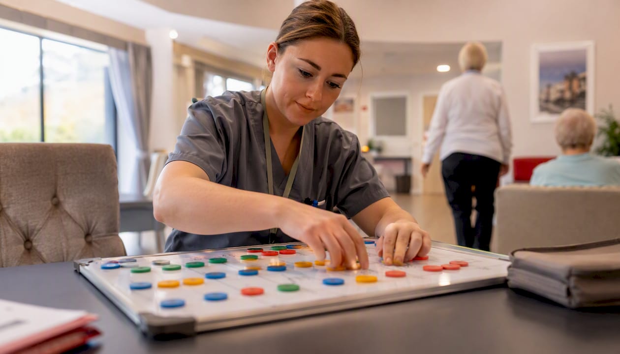 Care worker adjusting task and skills board