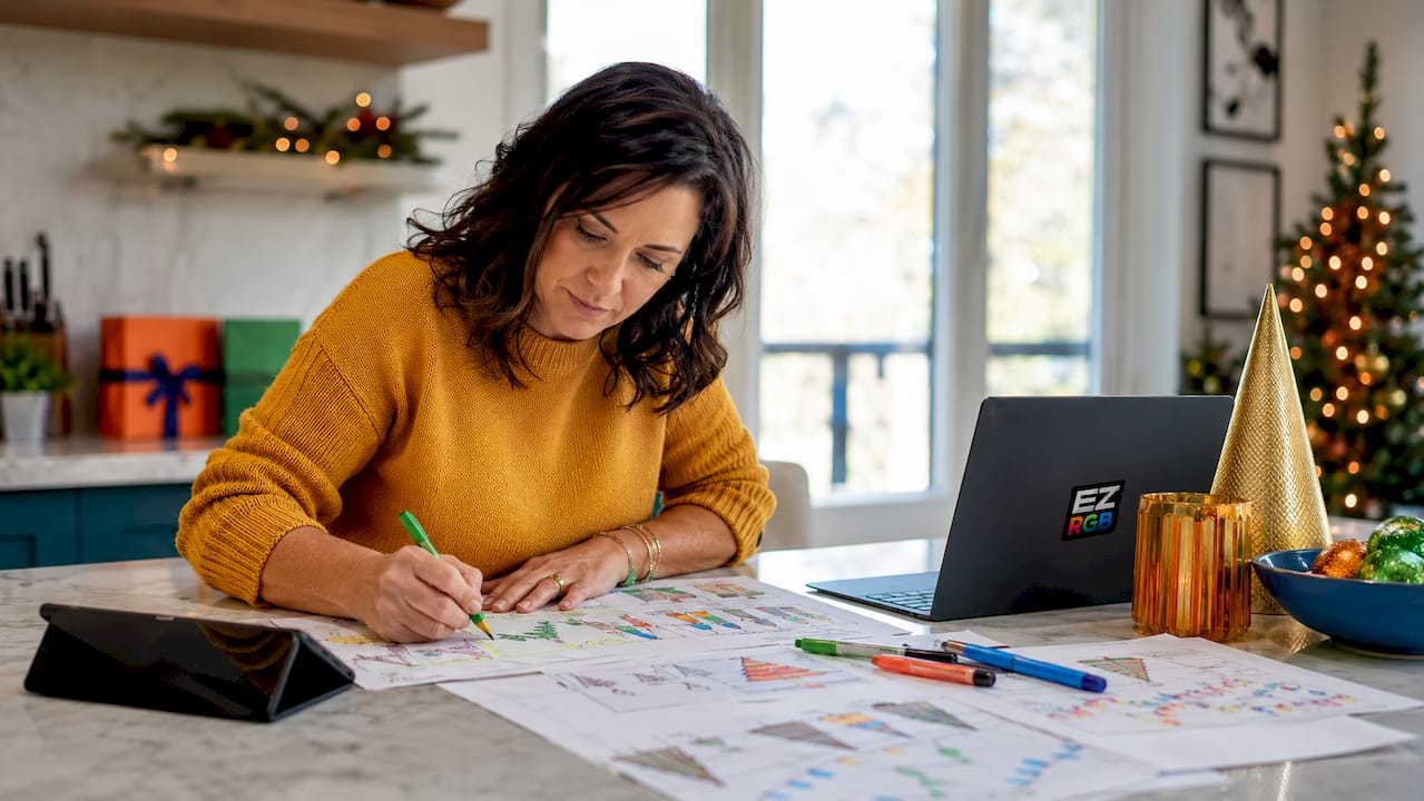 Woman planning holiday display at home table