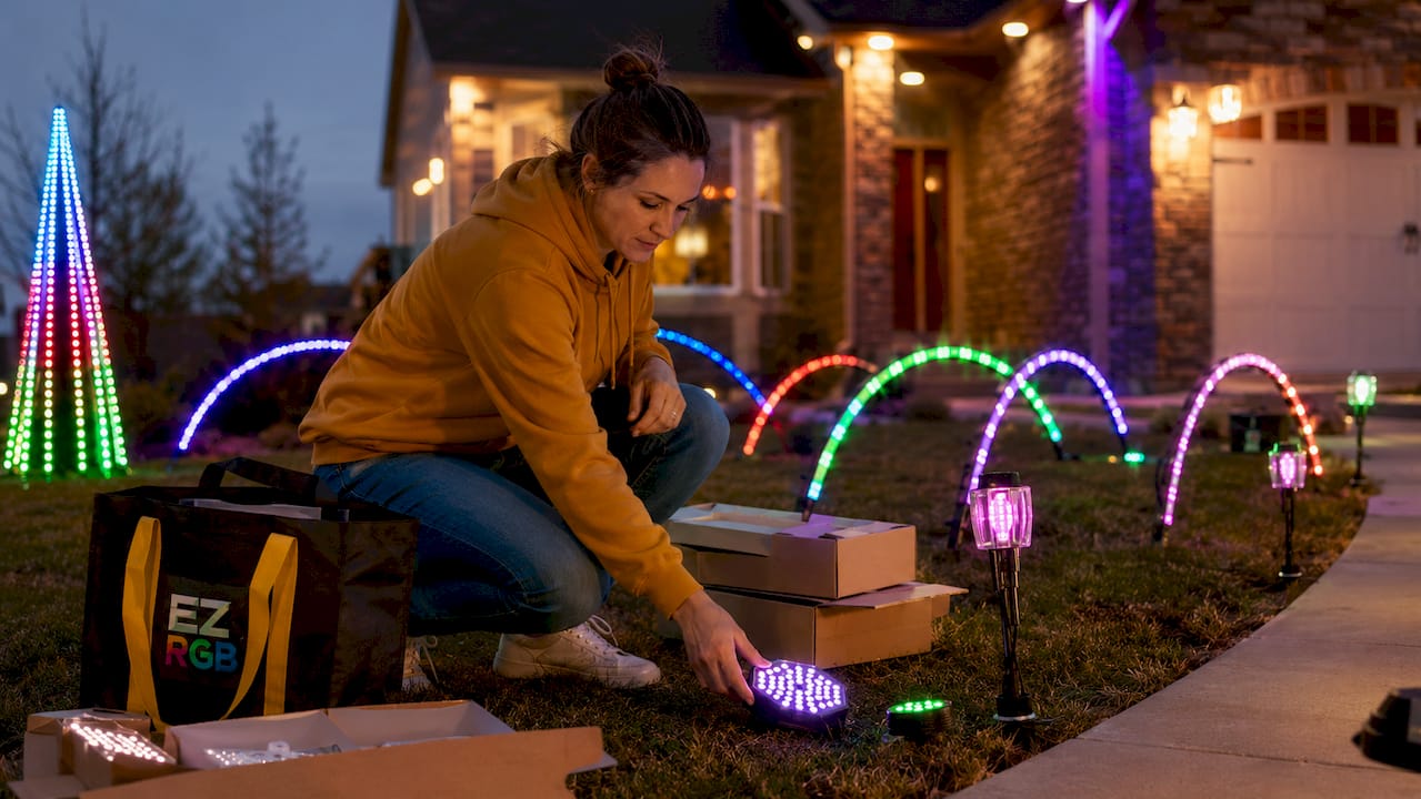 Woman unboxing plug-and-play light show props outdoors