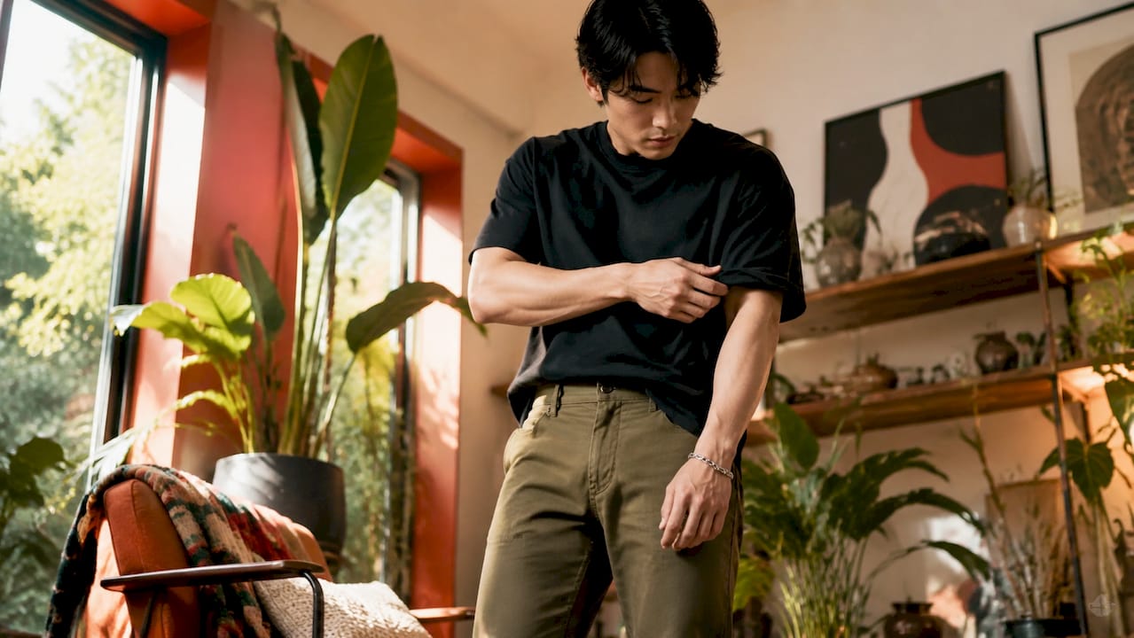 Man styling oversized t-shirt with slim-fit pants