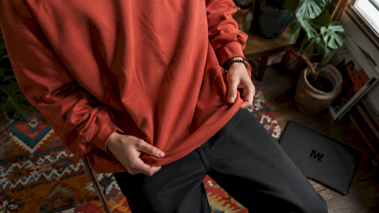Close-up of oversized streetwear sweatshirt being adjusted