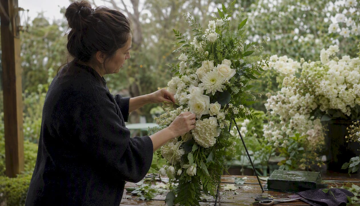 Floral designer assembling standing spray arrangement