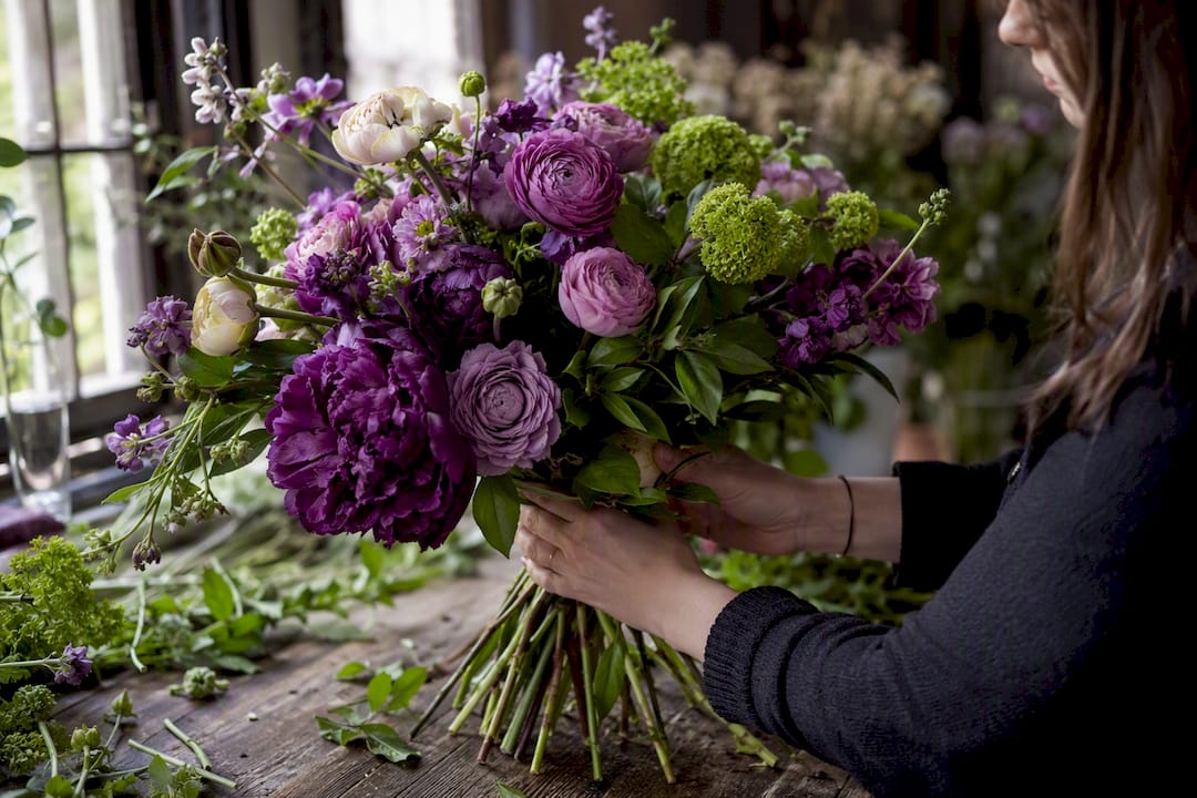 Florist arranging a mixed floral bouquet