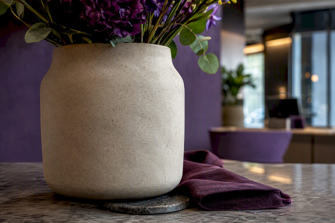 Matte ceramic vessel with reception flower stems