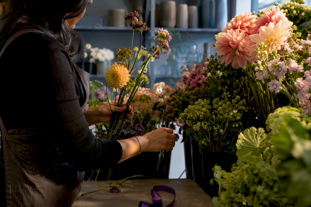 Florist selecting seasonal stems for delivery