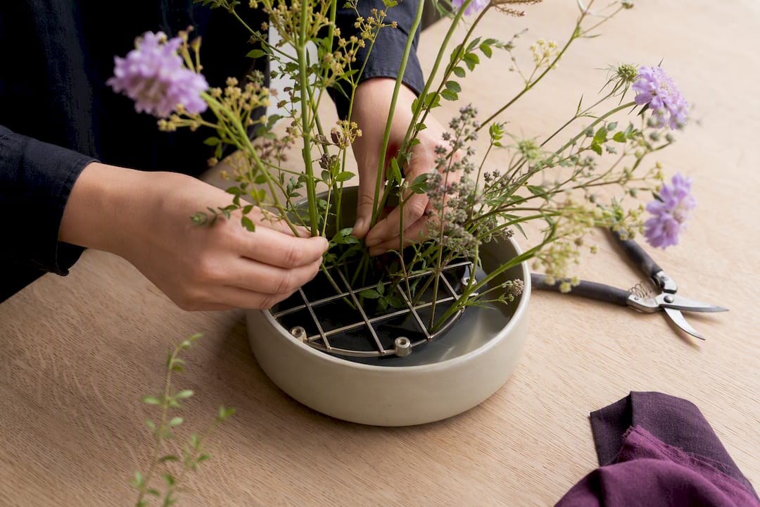 Airy stems spaced in reusable floral support
